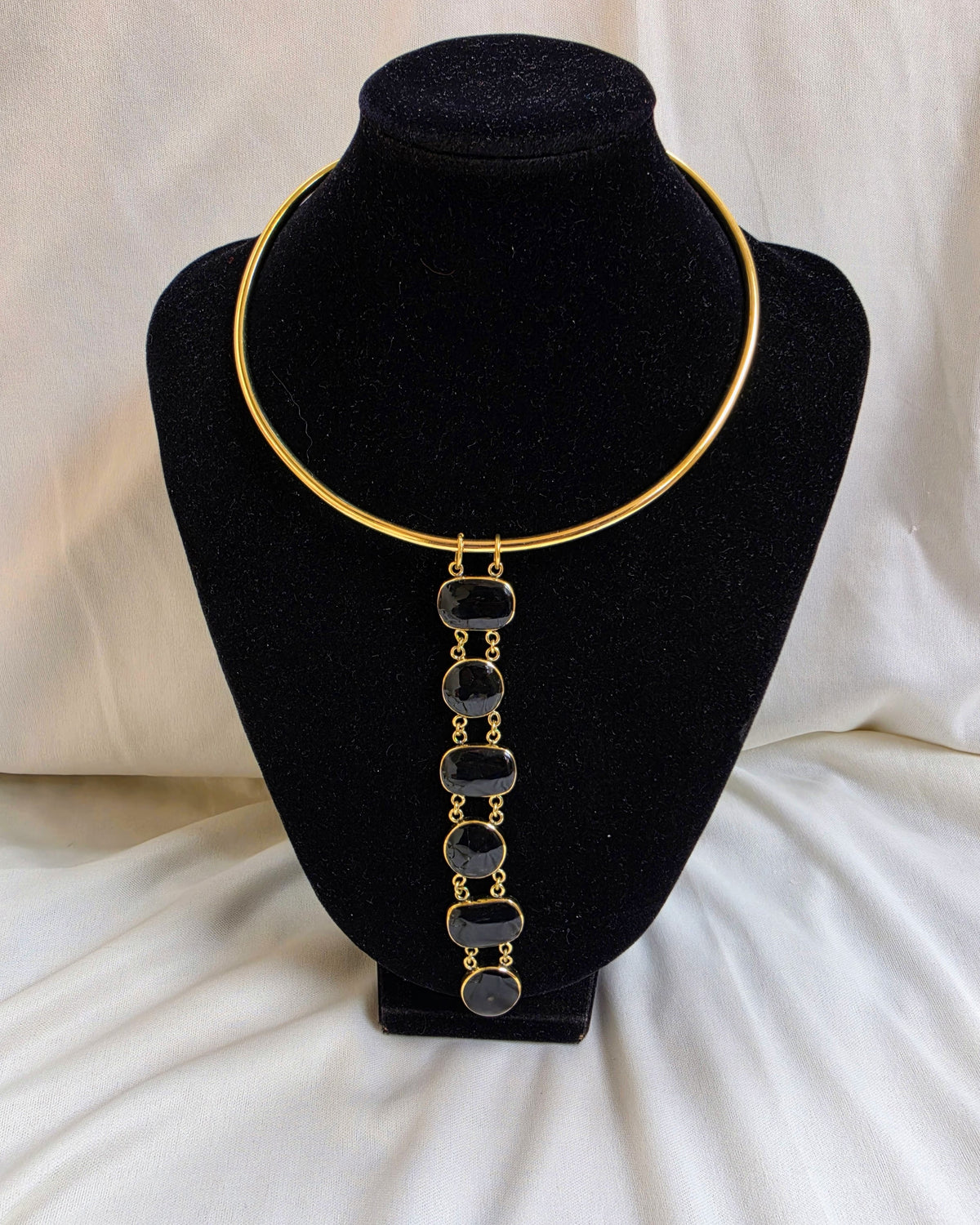 Asha Necklace - black stone bezel drop necklace on gold torque collar, product shot