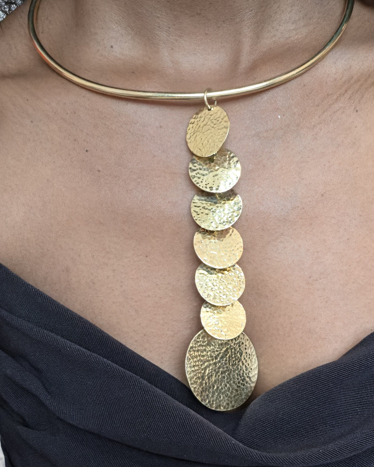 Mumbi Necklace - hammered gold disc drop necklace on gold torque collar, worn