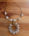 Furaha Necklace with white cowrie shells on a gold-tone wire collar and circular shell pendant