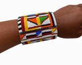 Maasai Cuff - wide geometric beaded cuff bracelet in bold Maasai colours, worn on wrist