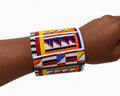 Maasai Cuff Small - wide geometric beaded cuff in white, red, orange and blue, worn on wrist