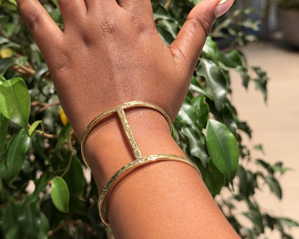 Ndare Bangle – hammered brass rectangular frame cuff worn on wrist, back view showing open frame