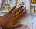 Hazina Ring - gold oval ring with sphere centrepiece worn on hand