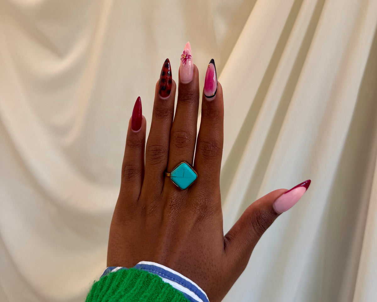 Anga Ring - vivid turquoise diamond-shaped stone in gold setting worn on hand