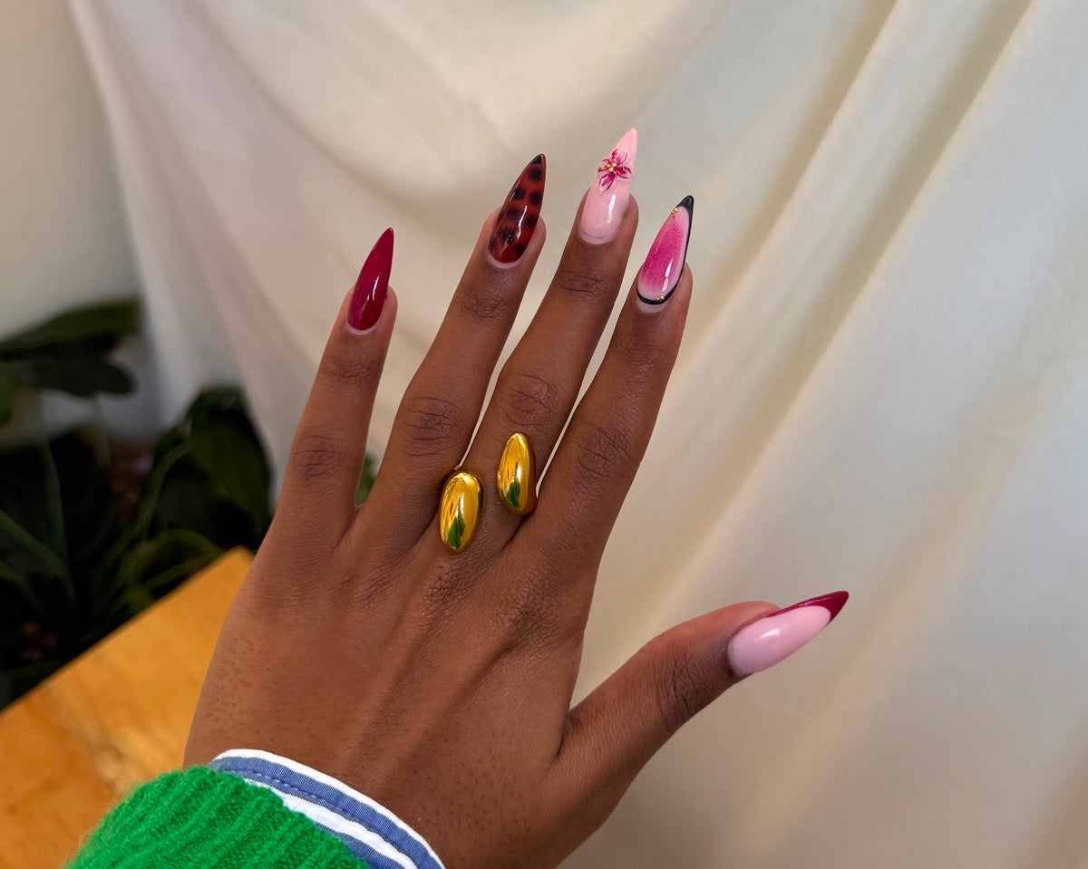 Amani Ring - two chunky polished gold dome rings worn together on hand